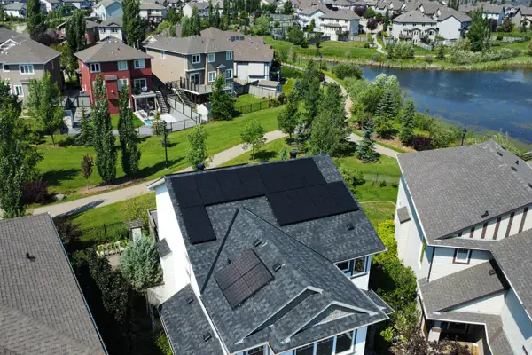 Aerial view of a solar panel installation on an Edmonton home beside a neighbourhood pond