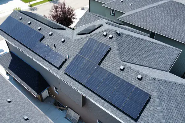 Aerial view of solar panels running along the roofline of a Leduc home